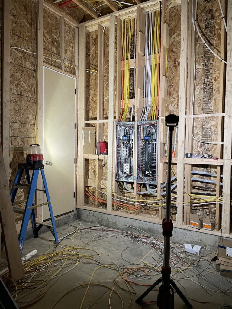 Electrical rough-in and panel installation in a room under construction by Kot Electric LLC in Kent, WA.