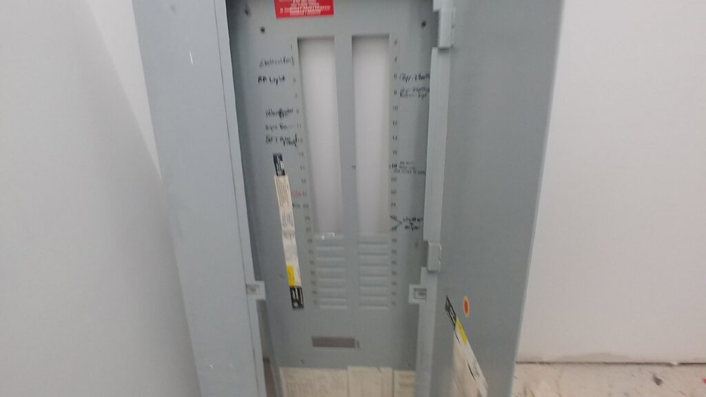 Electrical rough-in with two breaker panels installed on a wall during construction by A Renewable Electric LLC in Houston, TX.