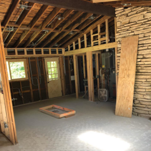 A room under construction with exposed framing and visible electrical rough-in wiring by Gen Pump & Power in Aurora, IL.