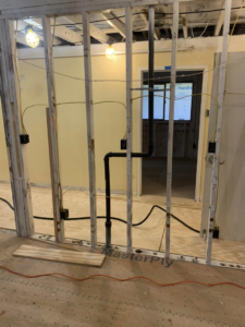 Electrical rough-in wiring and junction boxes in wall framing by Pacific Sun Electric in Oregon City, OR