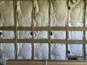 Electrical rough-in with insulation in a wall by Elving Electric in Marysville, WA