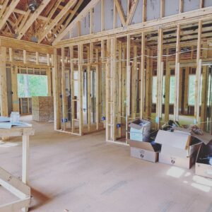 Interior of a new construction home showing electrical rough-in wiring and blue outlet boxes by Corey N Craig Electric LLC in Charlotte, NC.