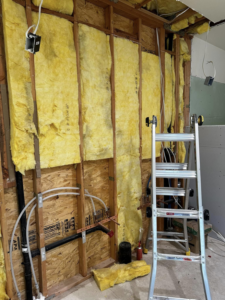 Electrical rough-in work with wiring and junction boxes visible in wall framing at a job site by Break-N-Run Services in Henderson, NV.