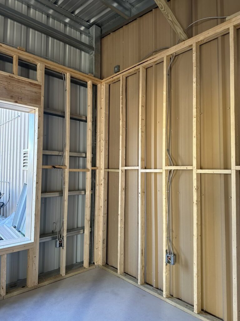 Electrical rough-in with wiring and junction boxes installed in wall framing by Justin Benevage Electrical, LLC in Lake Charles, LA