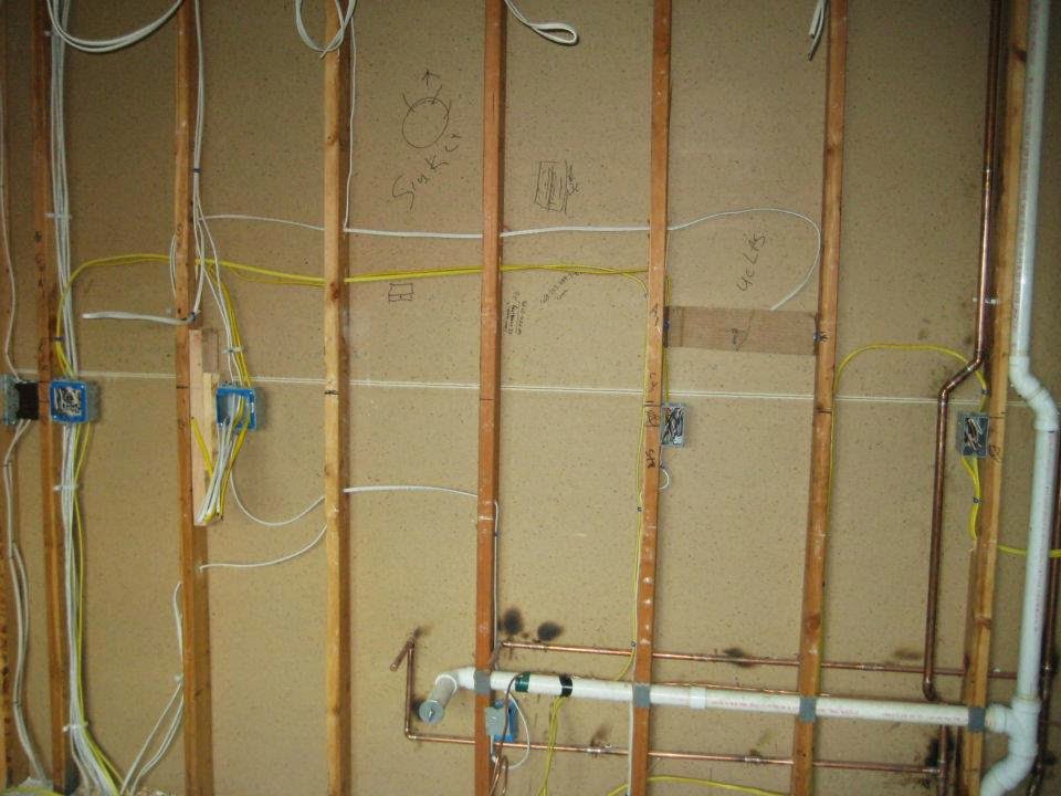 Exposed electrical rough-in wiring and boxes in a wall during construction by Barrios Electric LLC in Norwalk, CT.