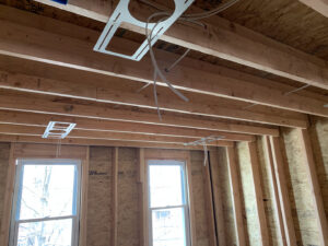 Electrical rough-in wiring and light fixture mounts installed in a ceiling by Moss Contracting in Philadelphia, PA.