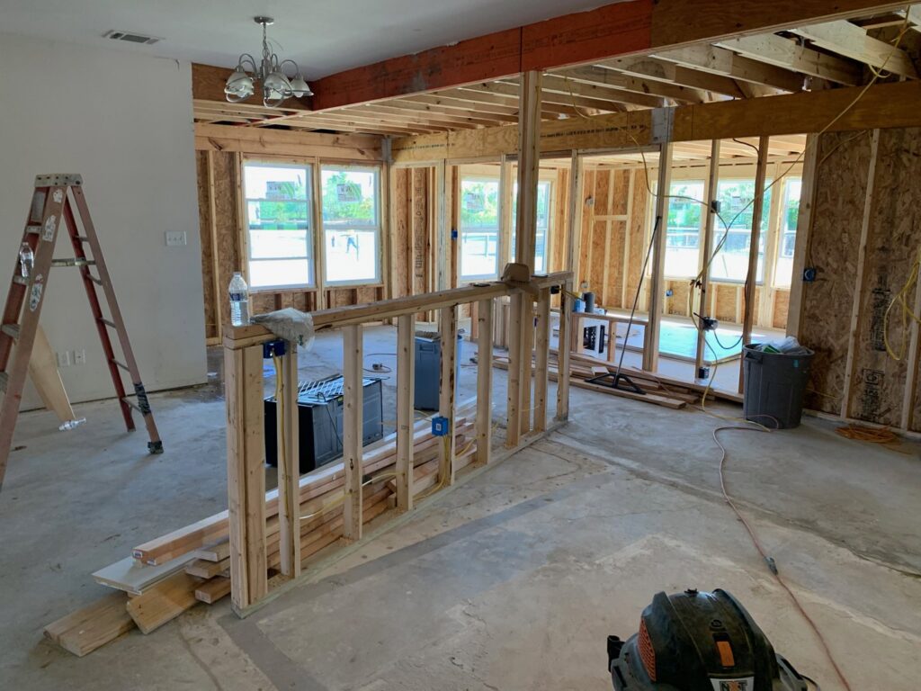 Exposed electrical wiring and blue outlet boxes during the rough-in phase of house construction by Volta Electrical LLC in Plano, TX.