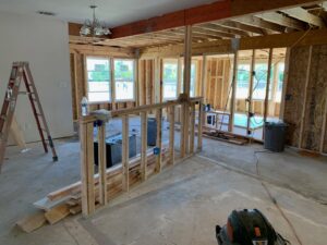 Exposed electrical wiring and blue outlet boxes during the rough-in phase of house construction by Volta Electrical LLC in Plano, TX.
