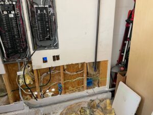 Exposed wall studs showing electrical rough-in wiring and outlet installation during construction by Flowers Electric in Aurora, CO.