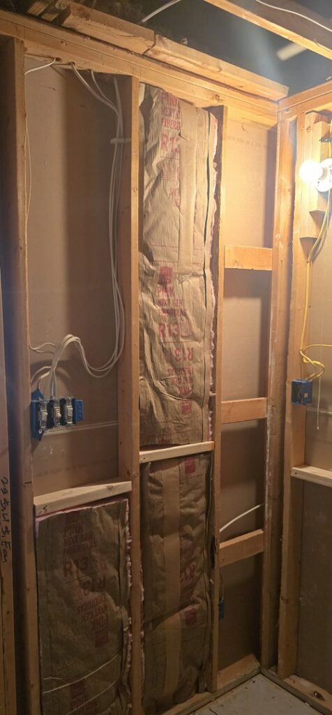 Electrical rough-in wiring and junction boxes installed within wall framing by Innovate Electric in Earth City, MO.