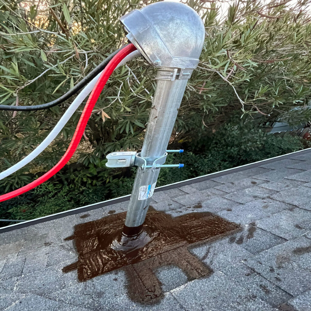 An electrical service mast with incoming wires installed on a residential roof by Fuse Service HVAC & Electrical Sacramento, CA