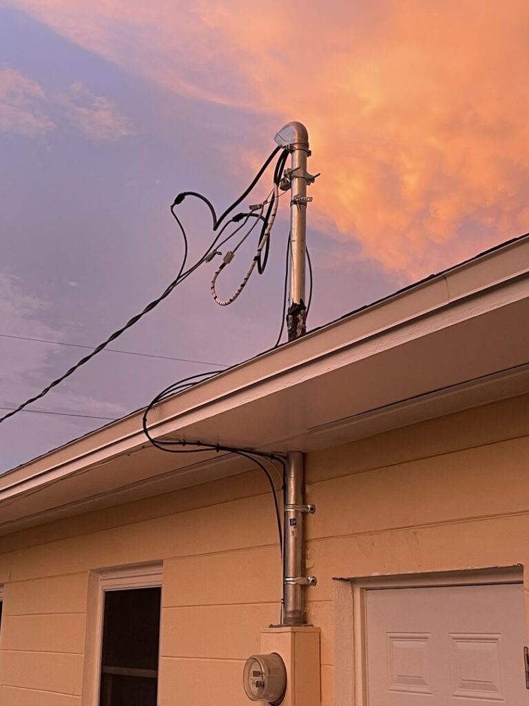 An electrical service mast and wiring installed on a residential roofline by Positricity in Clearwater, FL.