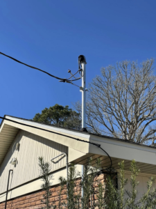An electrical service mast and wiring installed on the side of a house by Savoski's Electrical & AC, LLC in Sunset, LA