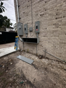 Electrical service panel installation in progress on a brick wall by A&f electric service in Houston, TX