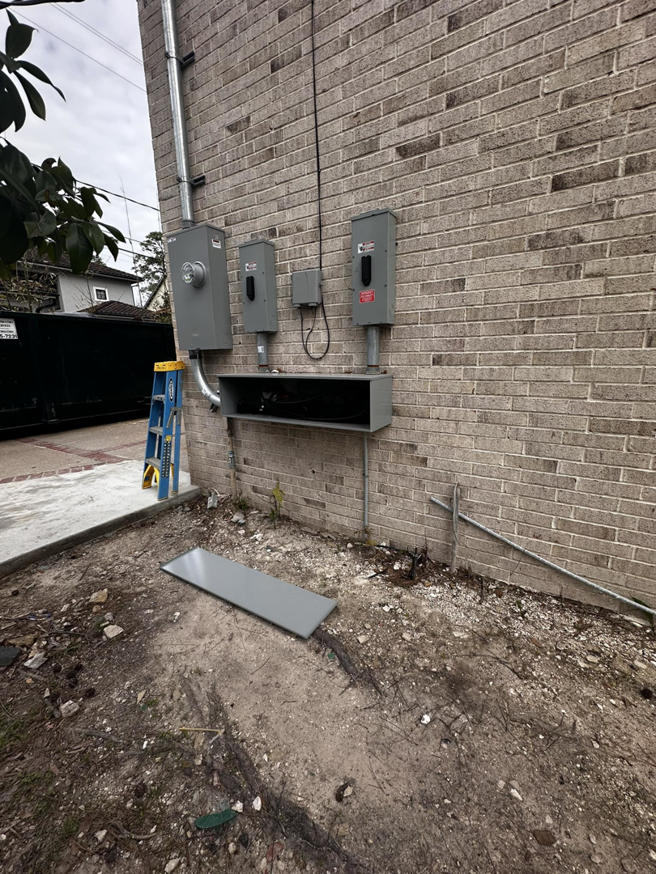 Electrical service panel installation in progress on a brick wall by A&f electric service in Houston, TX