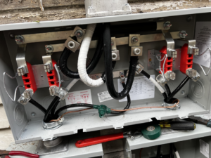 An open electrical service panel showing new wiring and connections by J. K. Quality Electric in Saint Bernard, LA.
