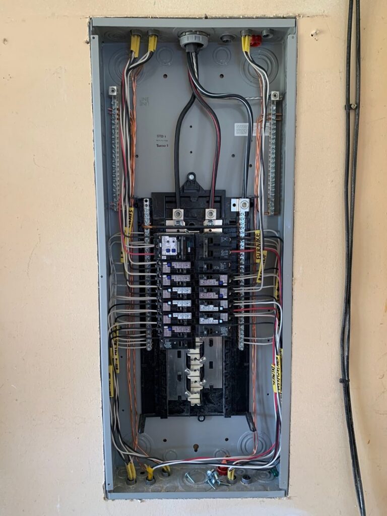 An open electrical service panel with neatly organized wiring, installed by Grason Electric in Fort Collins, CO.