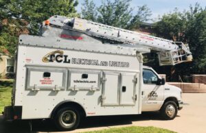 TCL Electrical and Lighting service truck with an extended ladder for elevated electrical work in North Aurora, IL
