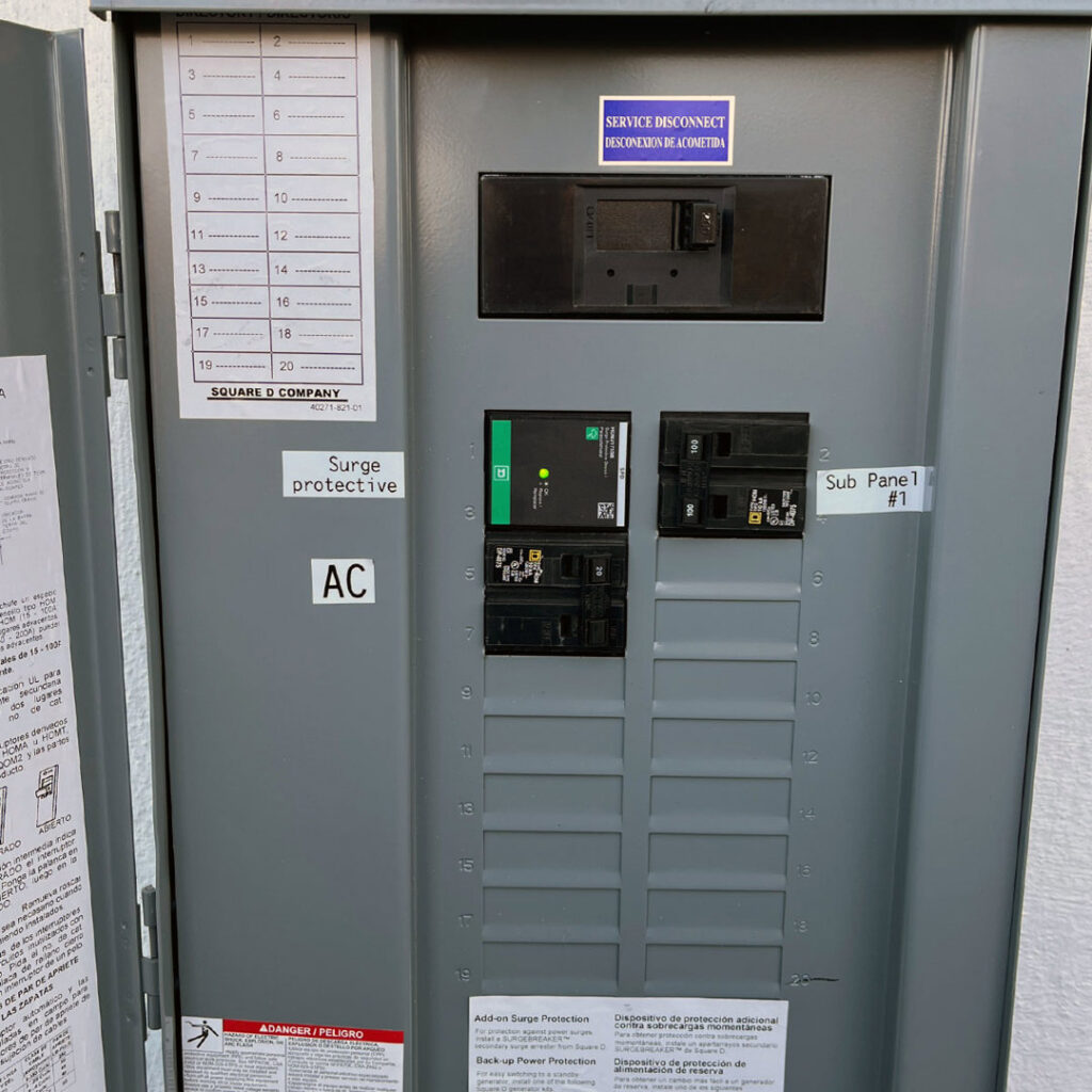 A newly installed electrical sub-panel with surge protection labels by Fuse Service HVAC & Electrical Sacramento, CA