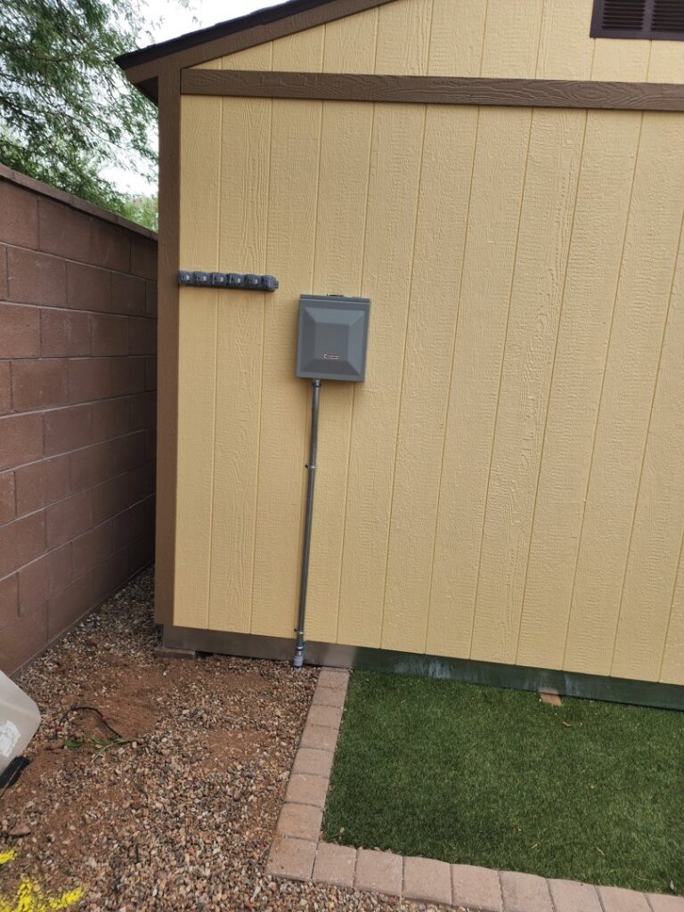 An electrical subpanel and conduit installed on the exterior of a shed by CDB Electrical LLC in Tucson, AZ.