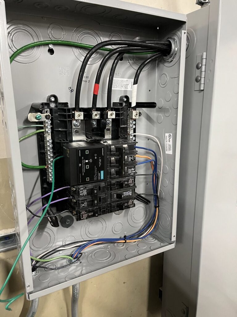 An open electrical subpanel showing new wiring and circuit breakers installed by Electrical Repair by Xact Services in Norman, OK.