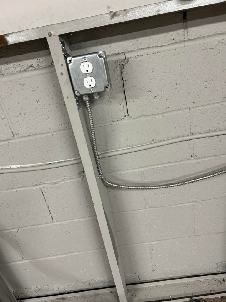 An electrical switch installation with multiple conduits on a wall by Ele Hvac Solutions Inc. in Birmingham, AL