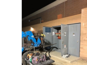 An open electrical switchgear cabinet being installed by High Tech Electric inc. with heavy equipment nearby in Van Nuys, CA.