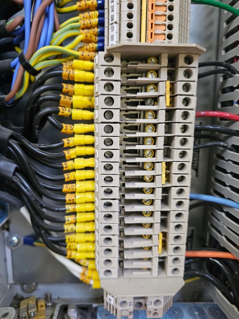 A close-up of electrical terminal blocks with numerous labeled wires, expertly installed by Trademark Elite Electrical Services in Butte, MT