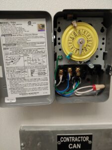 An open electrical timer switch with visible wiring and components, serviced by Right Electrical Services LLC in Raleigh, NC.