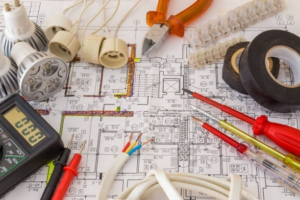 Electrical tools and blueprint for a project by Crawford Electric Co. LLC in West Columbia, SC.