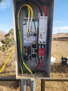 Detailed view of an electrical transfer switch box with wiring, installed by Minards Electric LLC in Dickinson, ND.