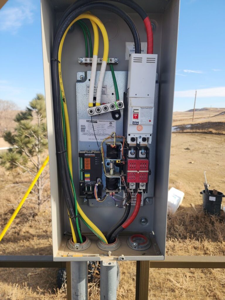 Detailed view of an electrical transfer switch box with wiring, installed by Minards Electric LLC in Dickinson, ND.