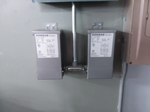 Two Dongan electrical transformers installed and connected with conduit by Wilderness Electric in Grand Rapids, MI
