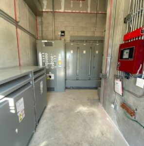 Large electrical transformers and panels installed in a commercial building by Tri-Area Electrical Construction in Cape Coral, FL.
