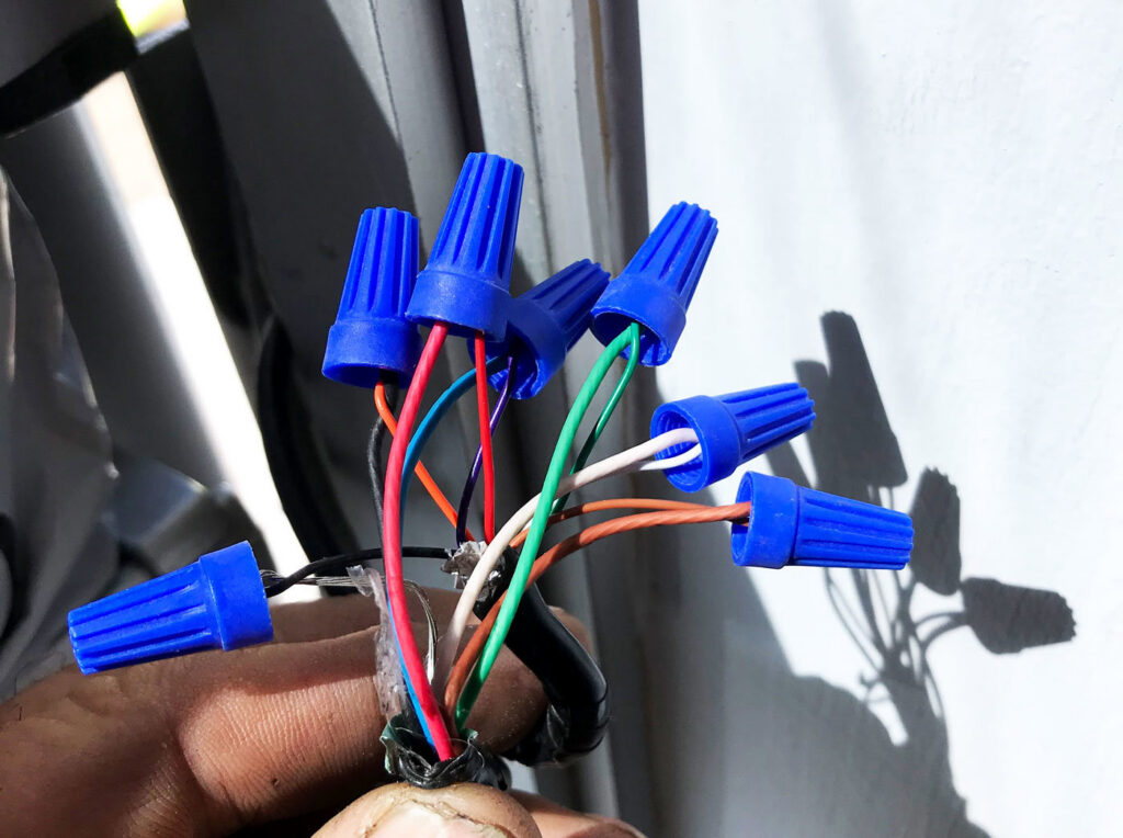Close-up of electrical wires connected with blue wire nuts during an installation by Ace Electric Inc. in Valdosta, GA.