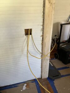 Electrical wires being roughed-in through a wall by Revamp Athens Electrical Company in Athens, GA.