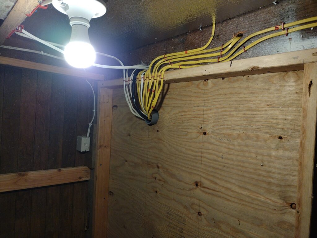 New electrical wiring and a light fixture installed on a wooden ceiling by GMD Electric in Springfield, OR.