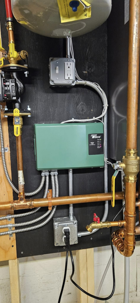 Close-up of electrical wiring, outlets, and a control box for a boiler system by Steven Polom, Journeyman Electrician in Springfield, MA.