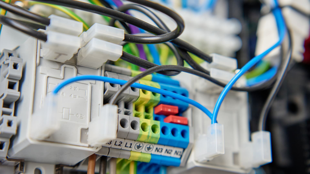 Close-up of complex electrical wiring and terminals in a control panel by Illiana Electrical in Whiting, IN