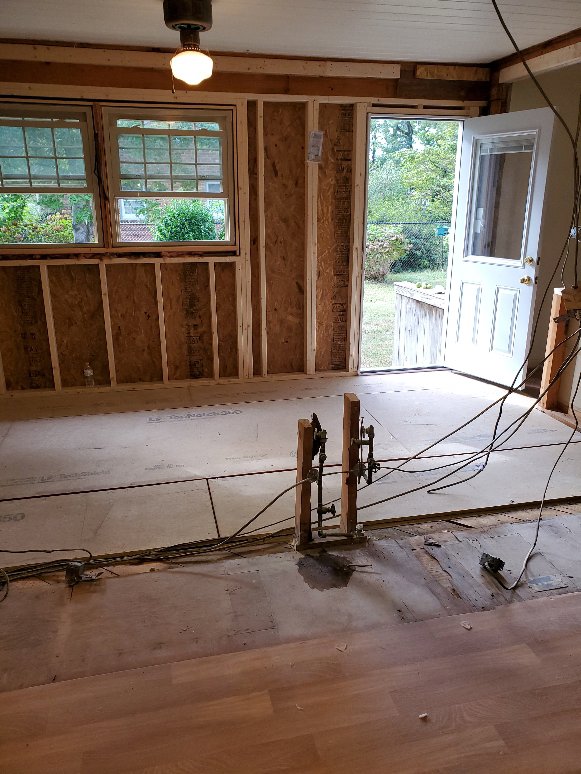 Electrical wiring being installed in a room during renovation with exposed studs by Neptune Electric in Virginia Beach, VA.