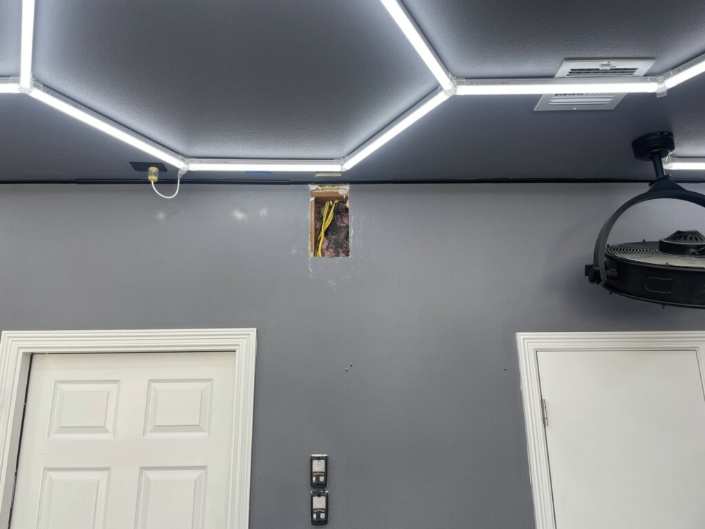 Exposed electrical wiring in a wall, part of a lighting installation project by Murray Electric & Plumbing in Broken Arrow, OK.