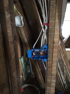 New electrical wiring and a junction box being installed in a wall by The Electric Way in Colorado Springs, CO.