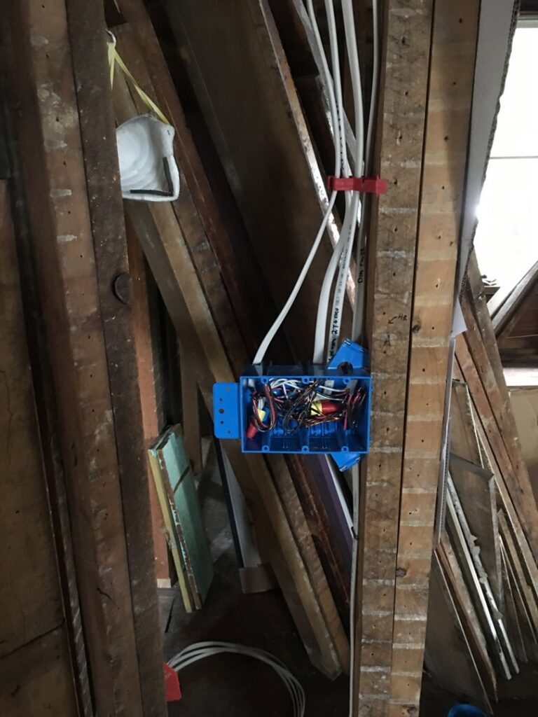 New electrical wiring and a junction box being installed in a wall by The Electric Way in Colorado Springs, CO.