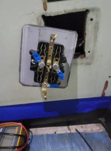 Close-up of electrical wiring and components being repaired or tested by Rain Man Thee Handyman in Hampton, VA.