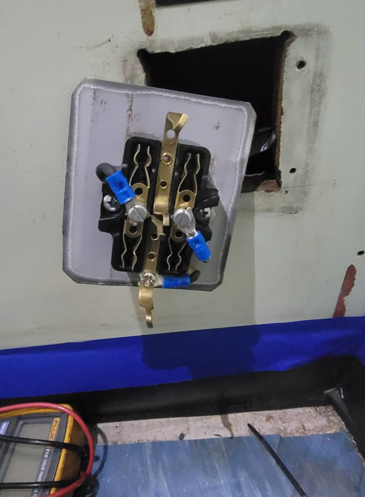 Close-up of electrical wiring and components being repaired or tested by Rain Man Thee Handyman in Hampton, VA.