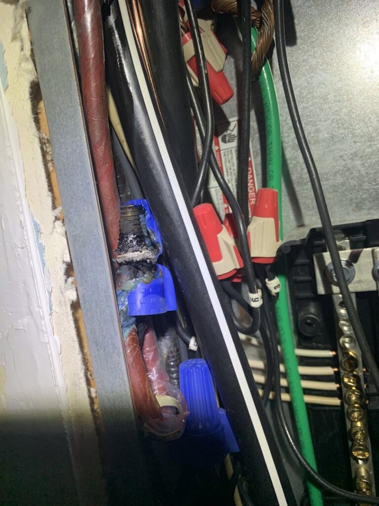 Close-up of electrical wiring and connections needing repair by Volt Doctors Raleigh, NC.