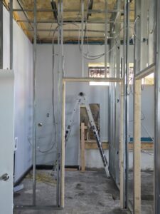 Electrical wiring rough-in visible within metal wall framing during a commercial project by DHJ Electric in Methuen, MA.