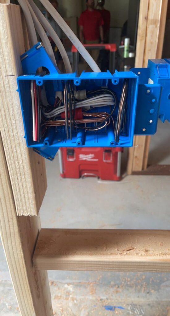 Electrical wiring inside a blue electrical box during the rough-in phase of an installation by G5 Electric, LLC in Evansville, IN.