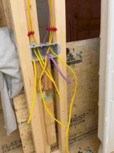 Electrical wiring rough-in with yellow and purple cables in an electrical box by J's Electrical & Maintenance Services, LLC in Columbus, OH.