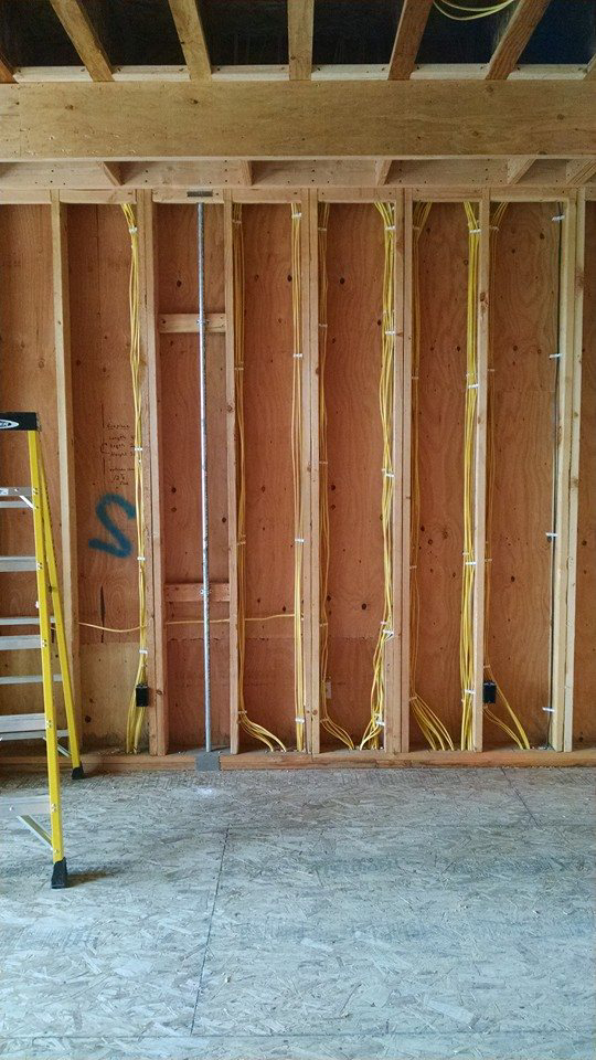 Electrical wiring rough-in in new construction framing by Kavanagh Electric in Fresno, CA.